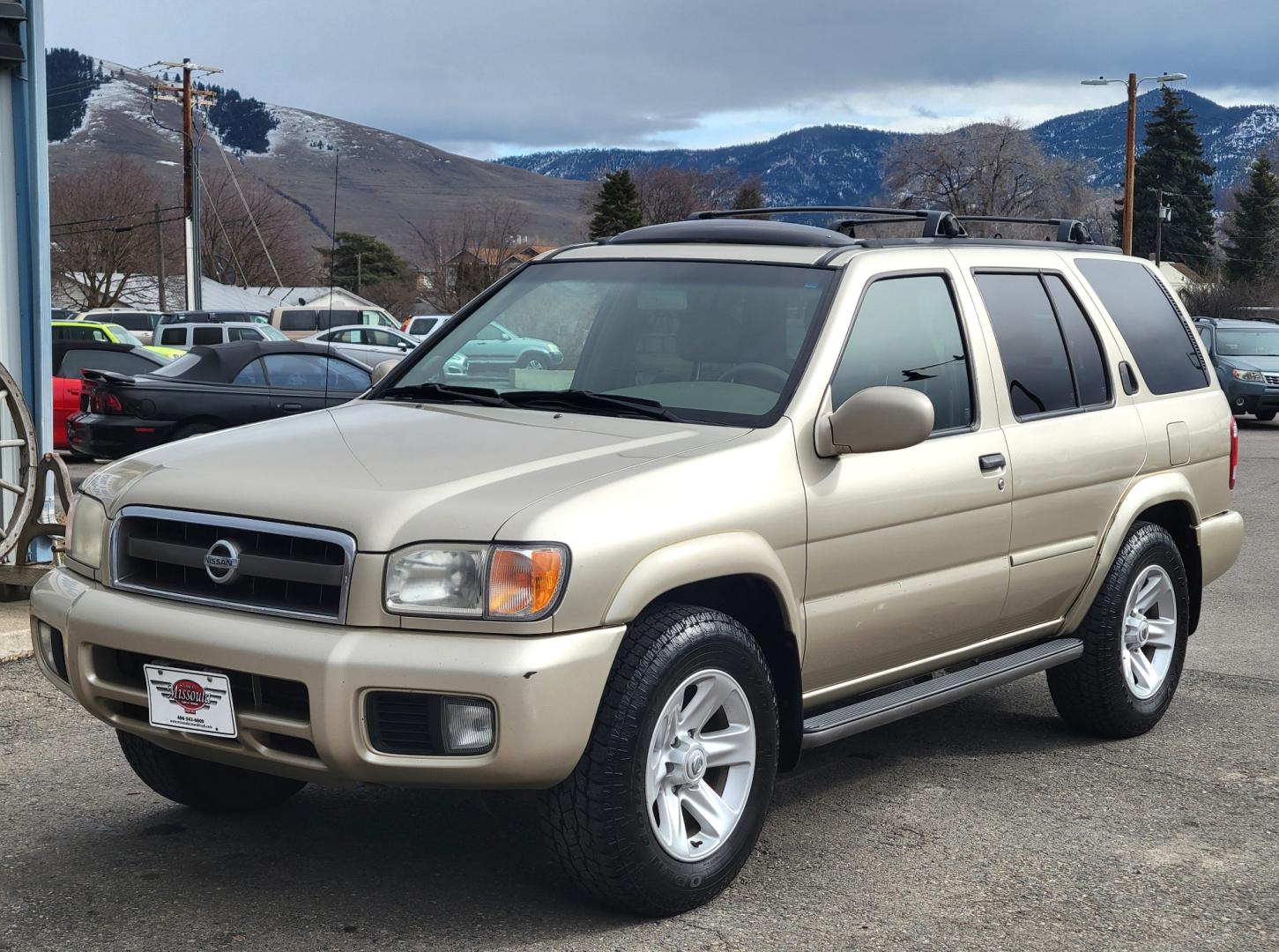 2002 Gold /Tan Nissan Pathfinder LE (JN8DR09Y22W) with an 3.5L v6 engine, Automatic transmission, located at 450 N Russell, Missoula, MT, 59801, (406) 543-6600, 46.874496, -114.017433 - 4WD SUV. 3.5L V6. Automatic Transmission. Heated Seats. Power Leather Seats. Power Sunroof. Air. Cruise. Tilt. AM FM CD Player. Power Windows and Locks. Because of the age, Financing is not available on this vehicle. - Photo#1